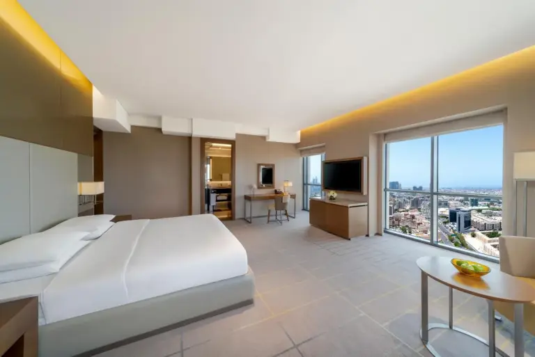 Suite bedroom at Hyatt Regency Dubai Creek Heights in Dubai with large windows and sitting area