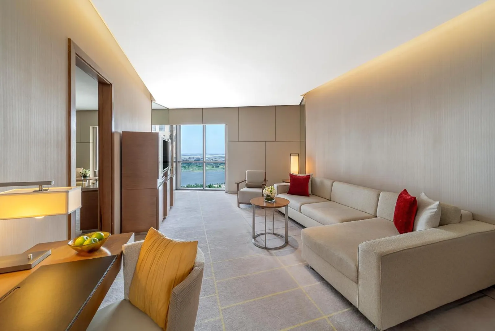 Suite living room at Hyatt Regency Dubai Creek Heights in Dubai with sectional sofa and city view