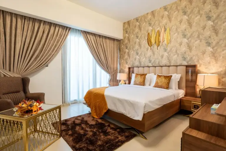 INA Homes luxurious bedroom with golden accents