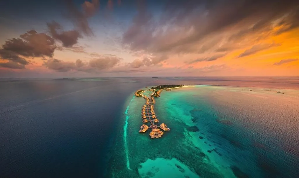 Aerial view of Intercontinental Maldives Maamunagau Resort showcasing the surrounding blue waters