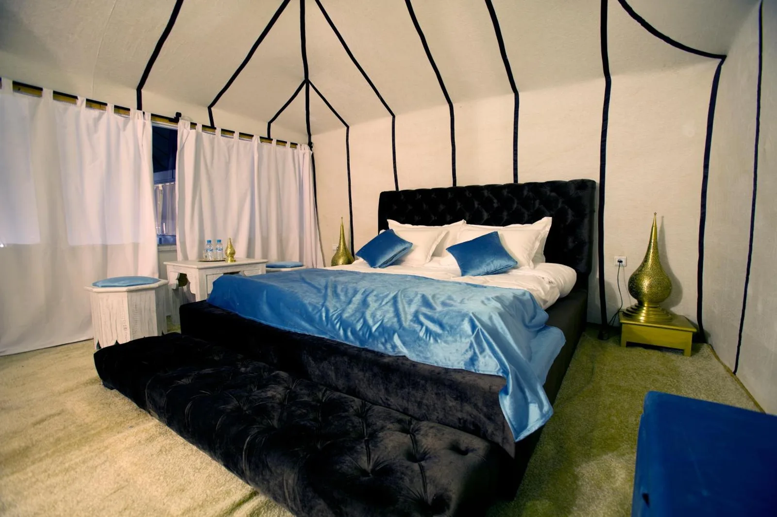 Chic tent ambiance at ITRAN ROYAL CAMP with plush bedding.