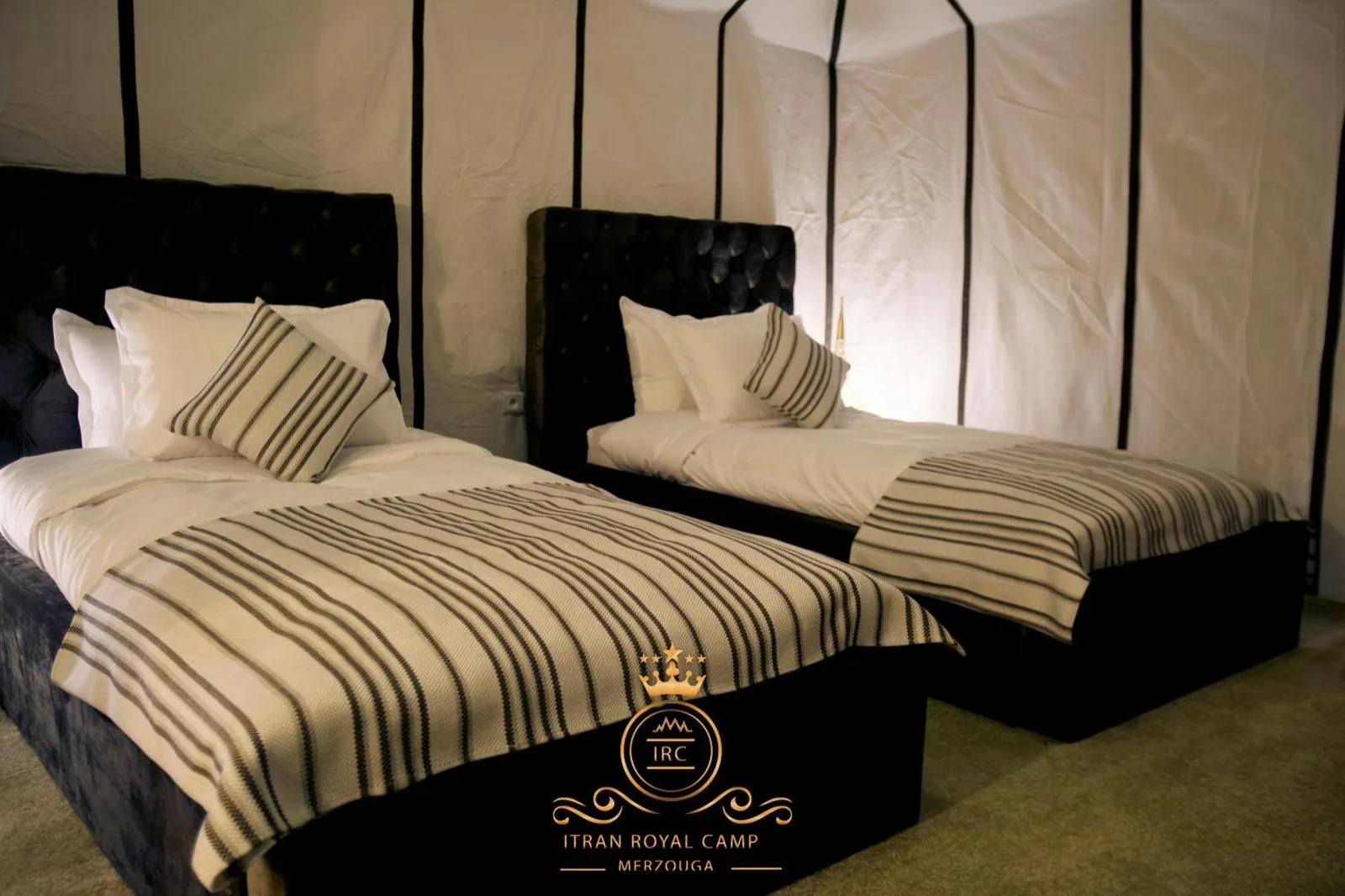 Twin bed setup in a tent at ITRAN ROYAL CAMP.