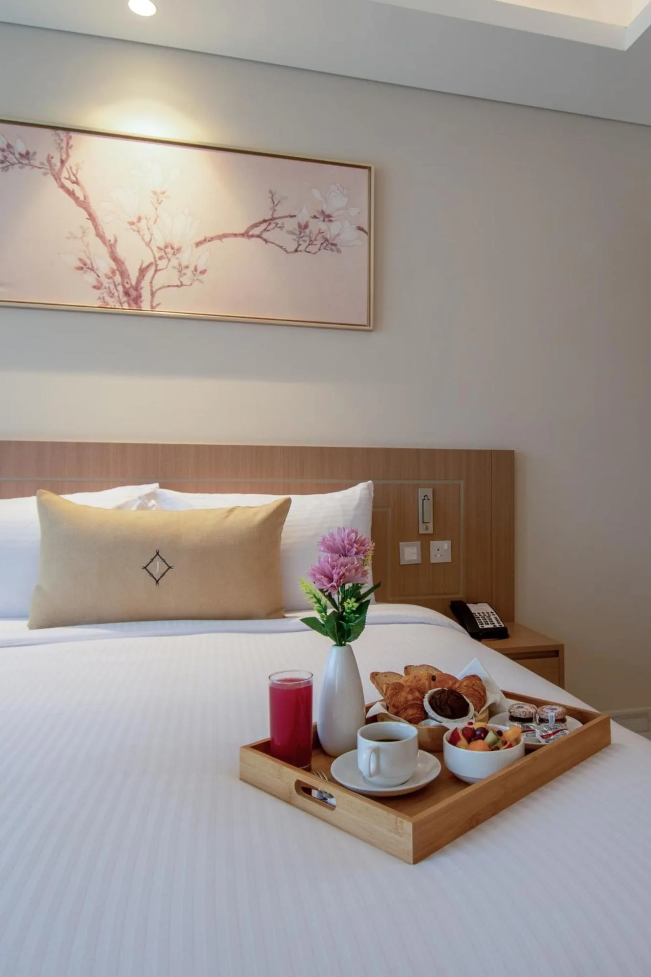 Breakfast tray on the bed inside Jood Hotel Apartments Dubai bedroom