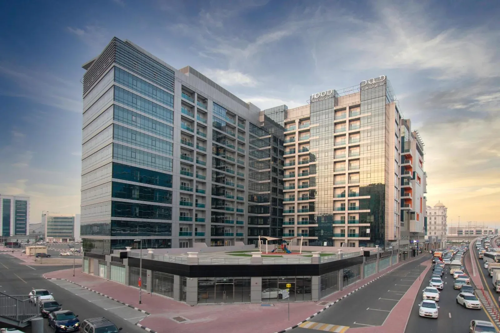 Exterior view of Jood Hotel Apartments in Dubai showing the modern high-rise hotel building