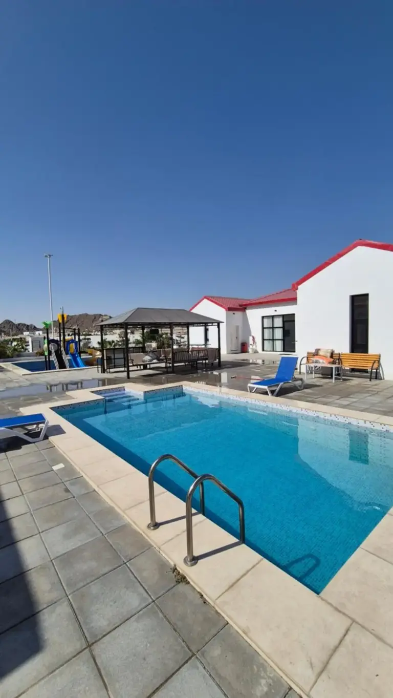 Swimming pool area at Jory Hatta Resort with sun loungers and a gazebo.