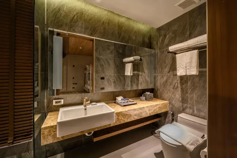 Modern bathroom at Kalima Resort and Villas Khao Lak with rainfall-style shower, vanity, and toilet in Khao Lak.