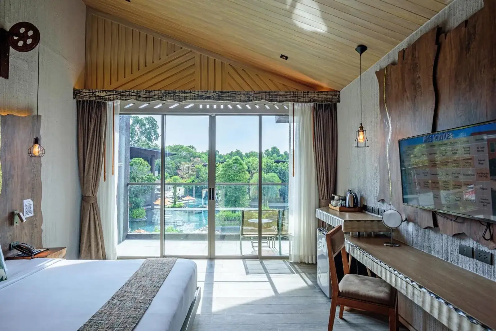 Guest room at Kalima Resort and Villas Khao Lak with balcony pool view and bright natural light in Khao Lak.