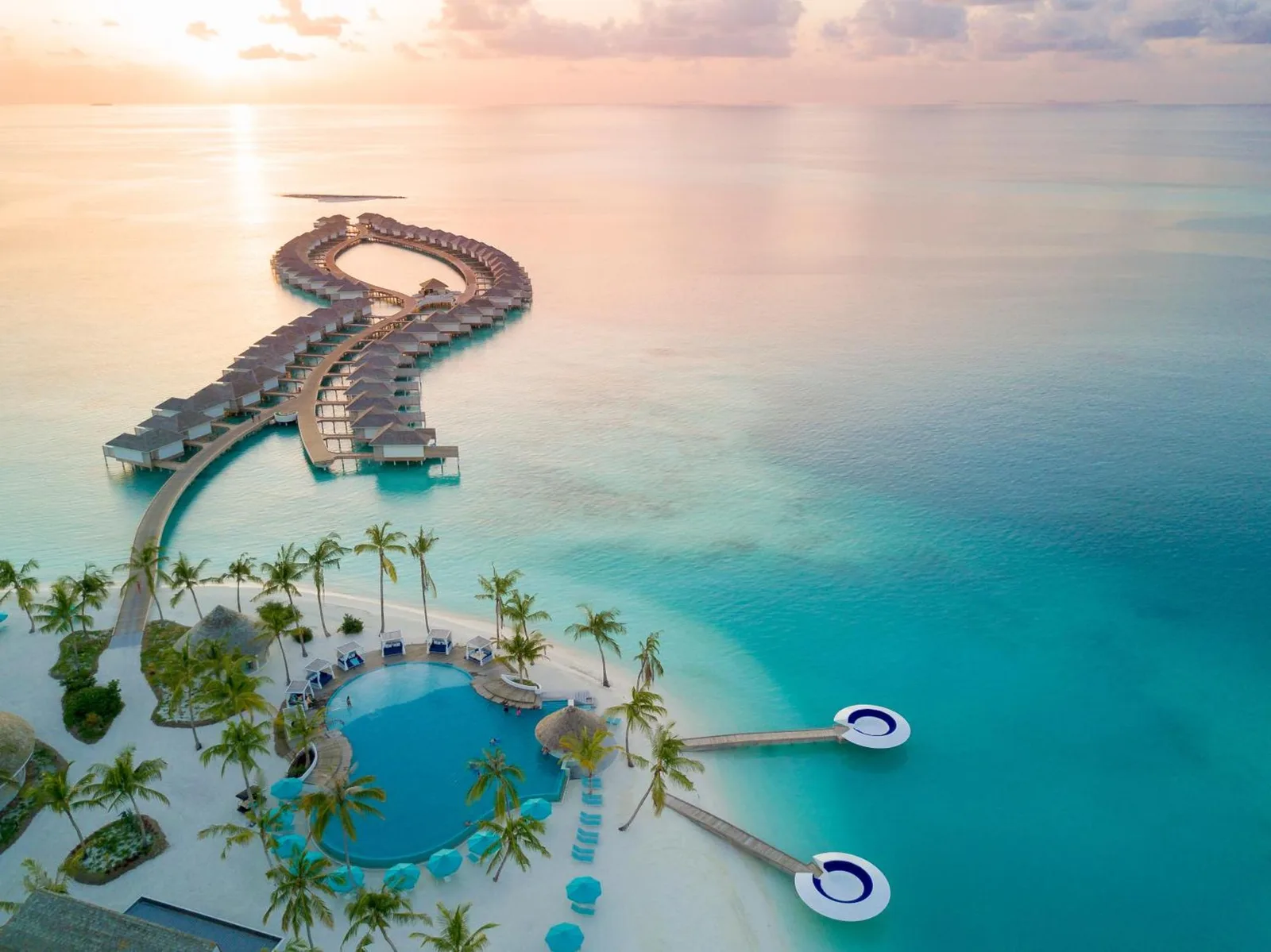 Aerial view of Kandima Maldives showcasing overwater villas and pool.