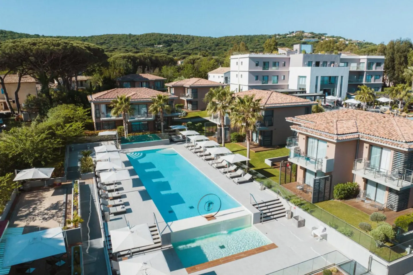 Kube Saint-Tropez pool area overlooking lush greenery