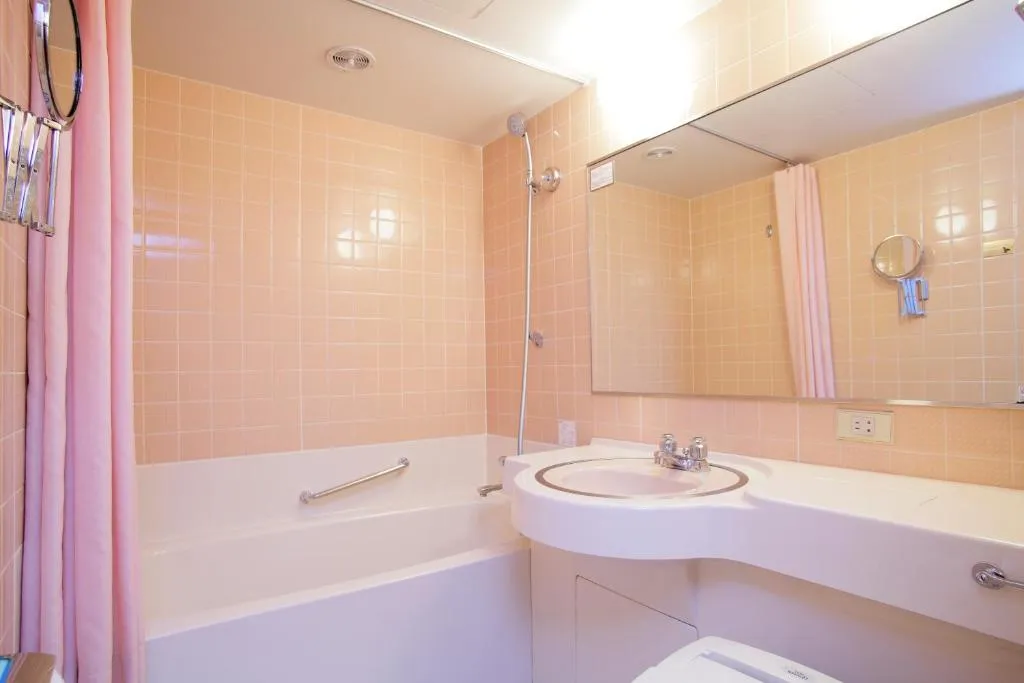 A modern bathroom at Kyoto Tokyu Hotel featuring a bath and shower
