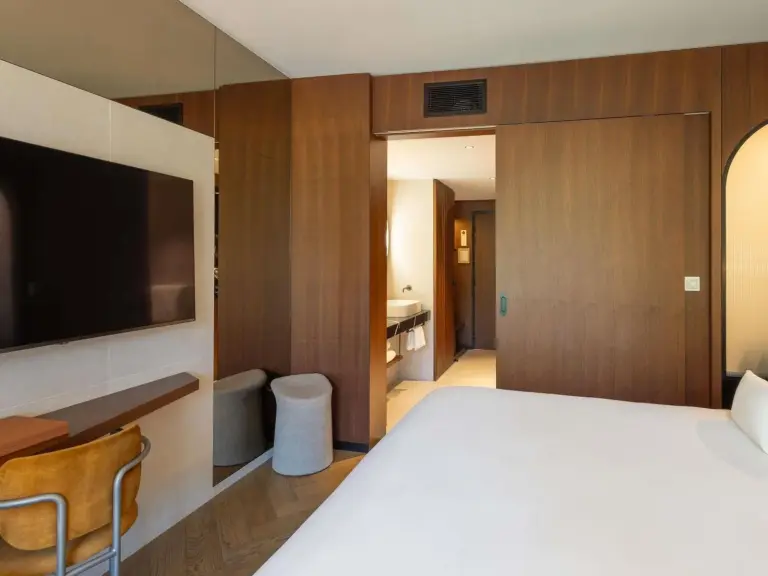 Guest room featuring a TV at L'Esquisse Hotel & Spa Colmar - MGallery Collection