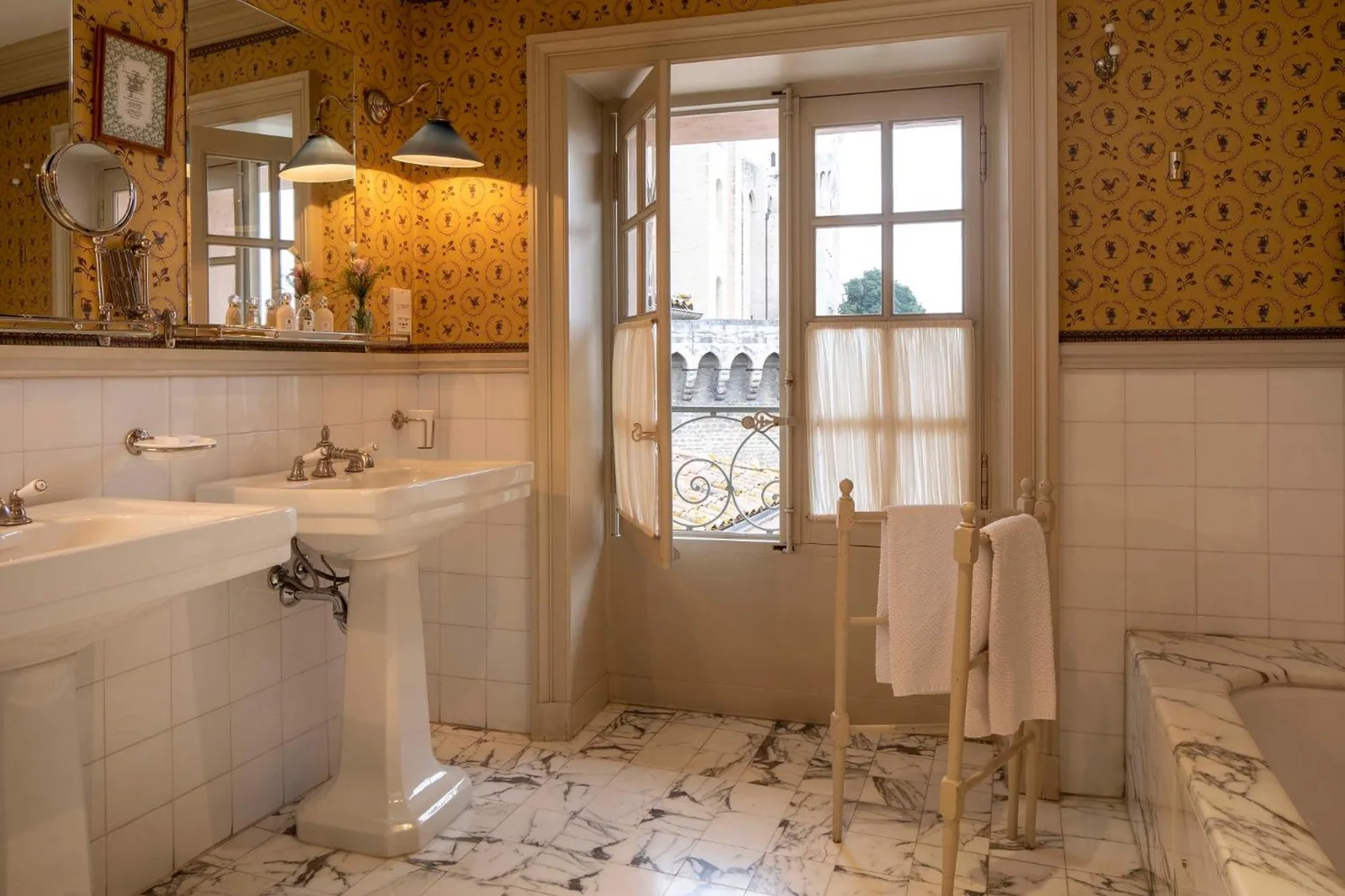 Elegant bathroom with a view at La Mirande hotel in Avignon
