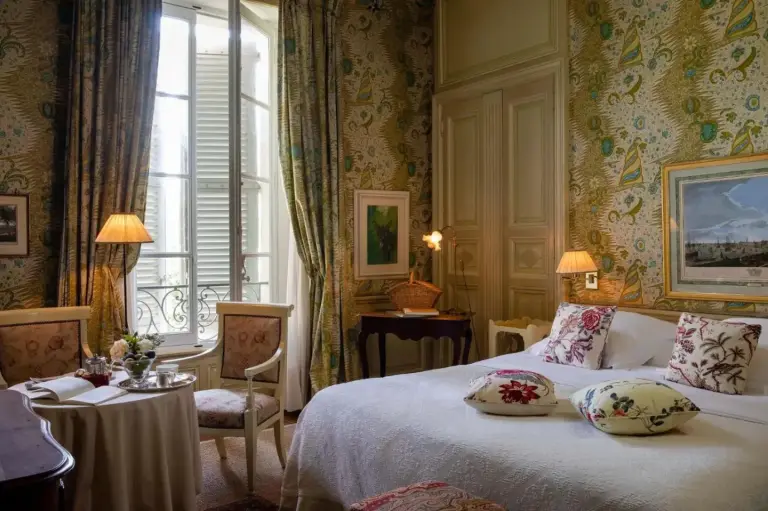 Luxury room with floral decor at La Mirande hotel in Avignon