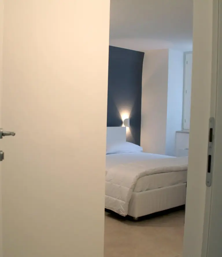 Lamia Room Rentals – Matera, Italy hotel – a bedroom with a bed and a door open at Lamia Room Rentals in Matera