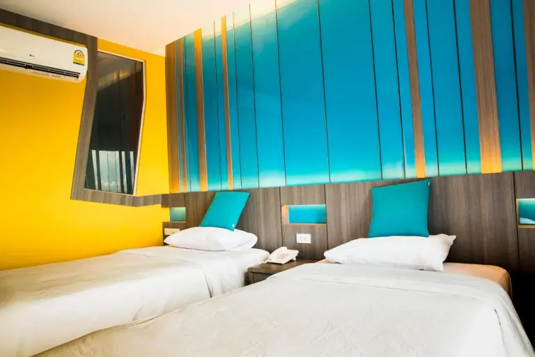 Twin guest room at Lantana Pattaya - SHA Extra Plus in Pattaya with balcony and colorful accent wall