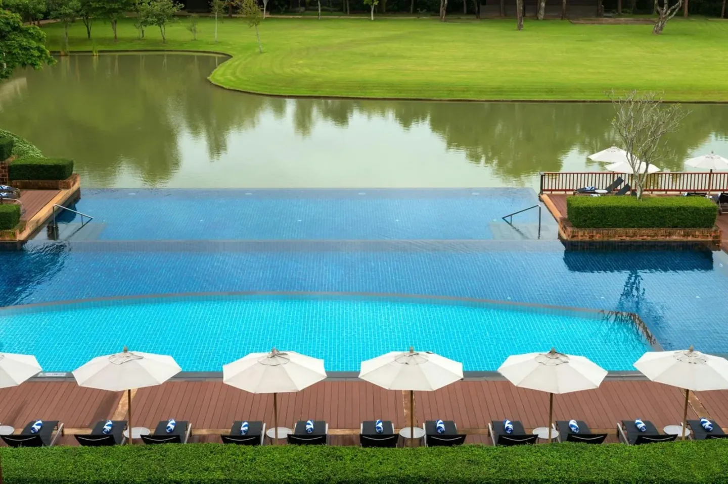 Le Meridien Chiang Rai Resort pool view with umbrellas
