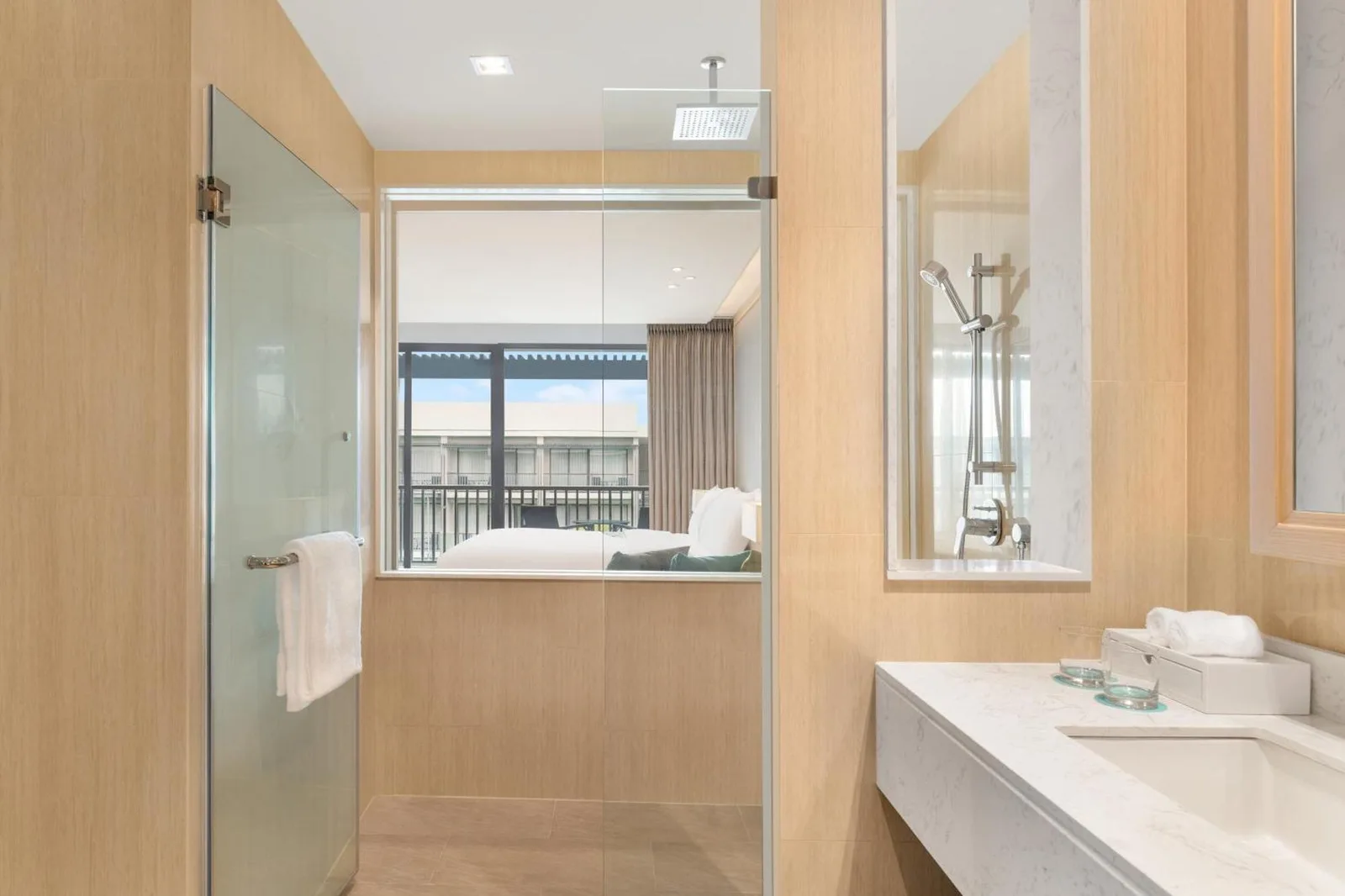 Bathroom shower and vanity area at Le Meridien Khao Lak Resort & Spa with glass enclosure and modern finishes.
