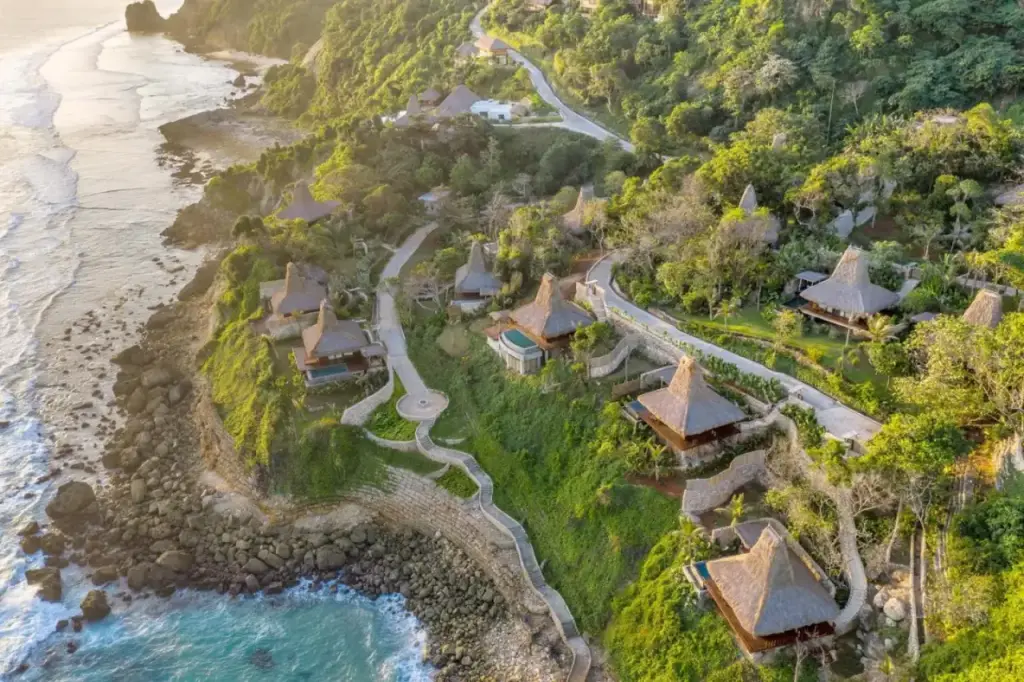 Luftaufnahme von Lelewatu Resort Sumba mit der üppigen Landschaft und der nahe gelegenen Küste.