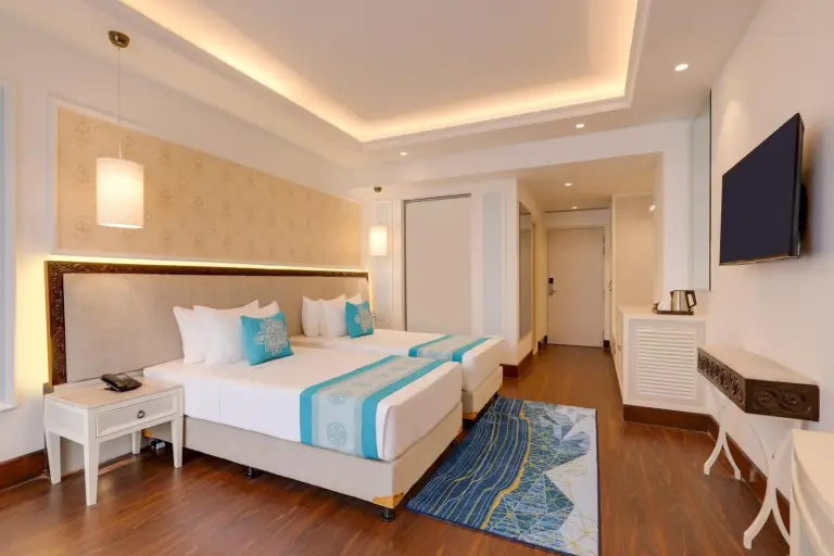 Twin beds in a guest room at Lemon Tree Premier Budhanilkantha Kathmandu, Nepal with elegant decor