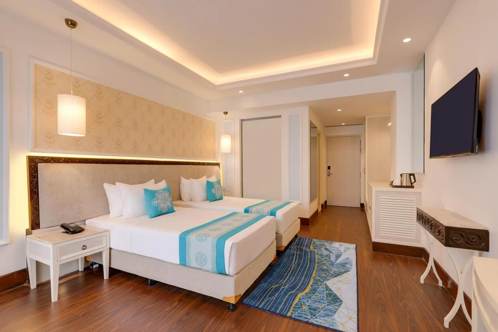 Twin beds in a guest room at Lemon Tree Premier Budhanilkantha Kathmandu, Nepal with elegant decor