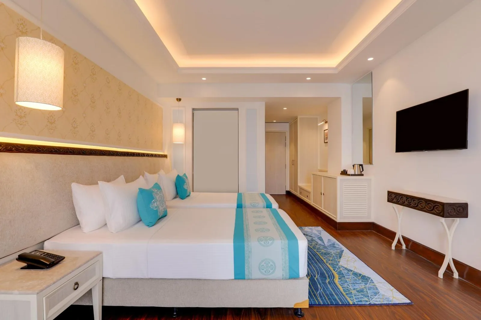Twin room interior at Lemon Tree Premier Budhanilkantha Kathmandu, Nepal with modern lighting and wood flooring