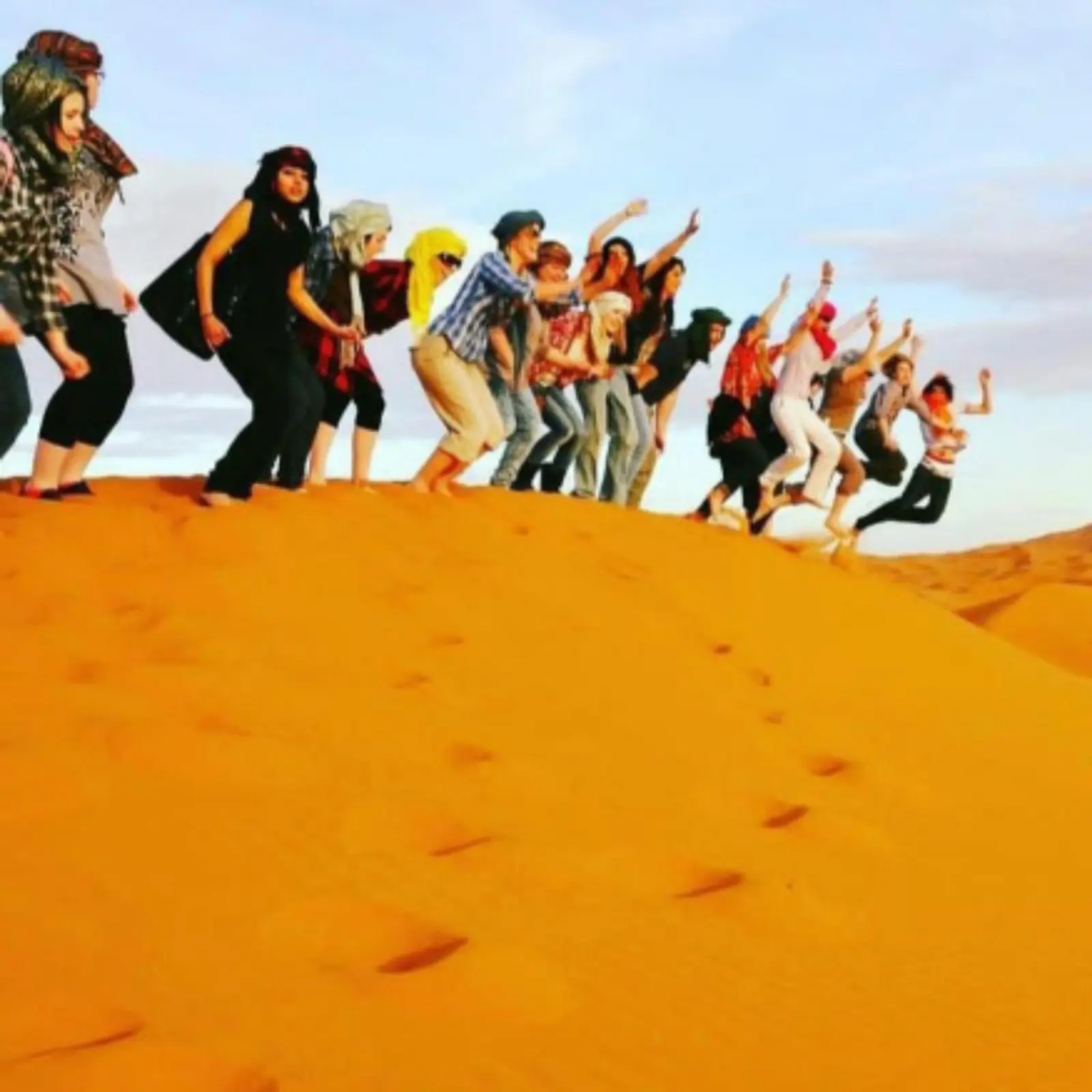 Group of people having fun at Les Pyramides Luxury Desert Camp in Merzouga