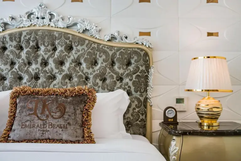 LK Emerald Beach - SHA Extra Plus in Pattaya bed with ornate headboard and bedside lamp