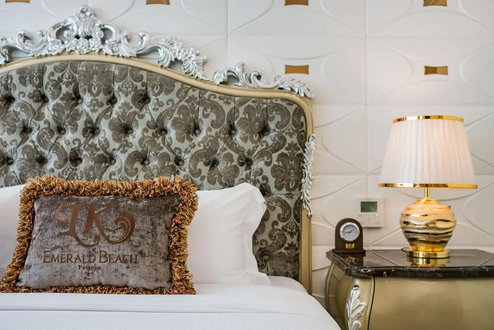 LK Emerald Beach - SHA Extra Plus in Pattaya bed with ornate headboard and bedside lamp