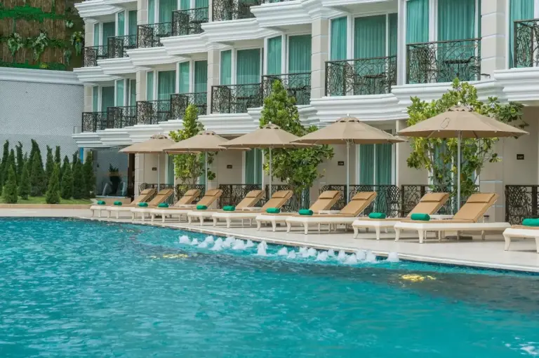LK Emerald Beach - SHA Extra Plus in Pattaya poolside lounge chairs and guest rooms overlooking the pool