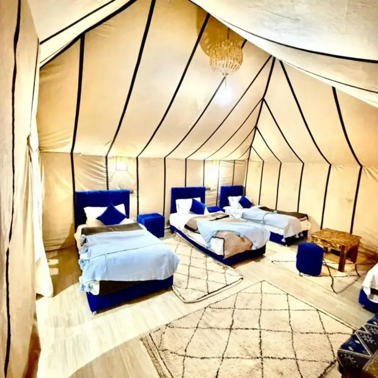 Twin room at Luna Desert Luxury Camp in Merzouga with blue beds and modern tent design