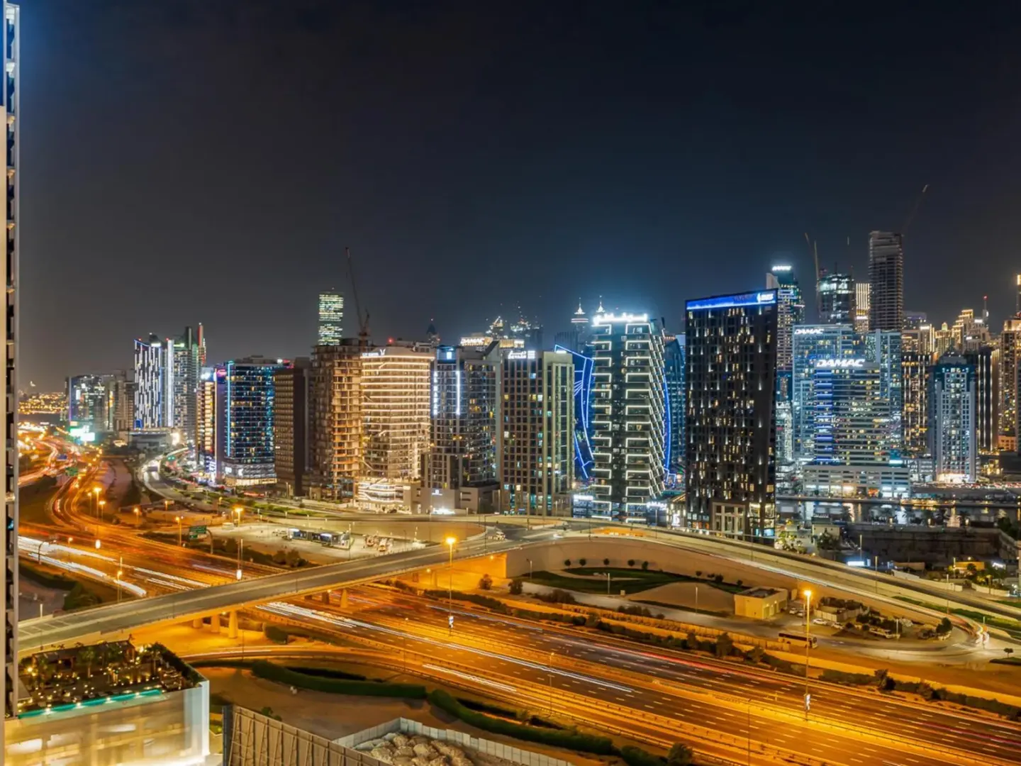 Luxury 1BR with Burj Khalifa View in Dubai, showcasing the city skyline at night.