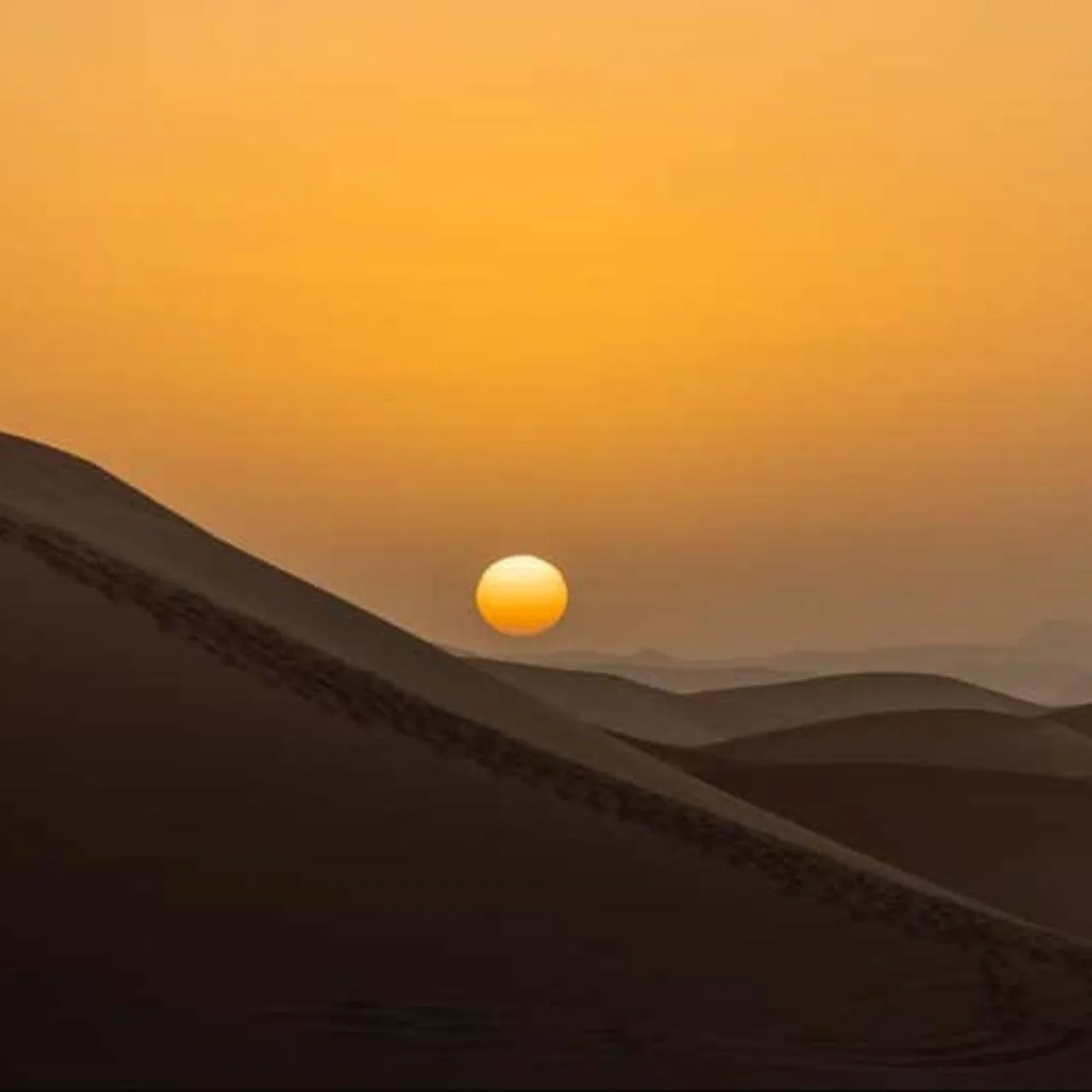 Sun setting over the dunes near Luxury Camp View in Merzouga
