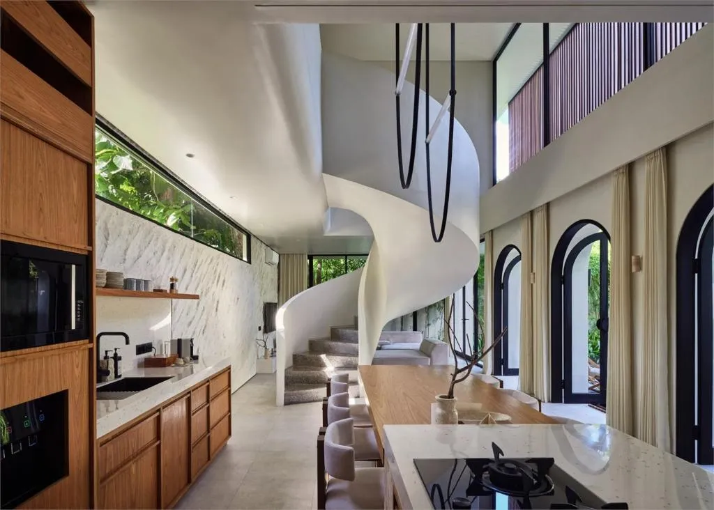Lyvin Bingin Villas interior featuring a spiral staircase and kitchen