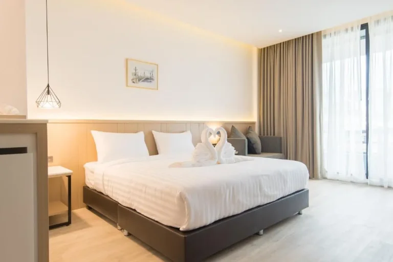Romantic suite with decorative swan towels at Madison Bangkok Hotel