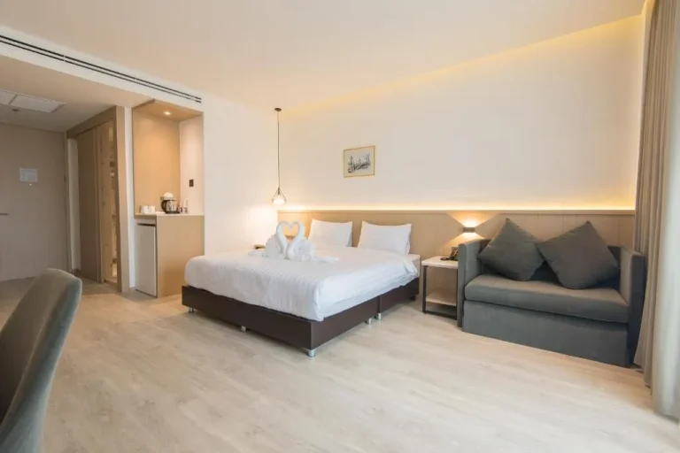 Stylish suite at Madison Bangkok Hotel with cozy seating