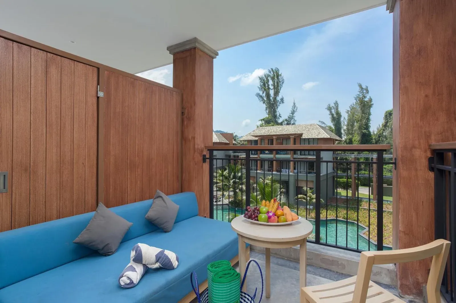 Balcony terrace at Mai Khaolak Beach Resort & Spa - TUIBLUE Mai Khaolak with seating, fruit, and pool views.