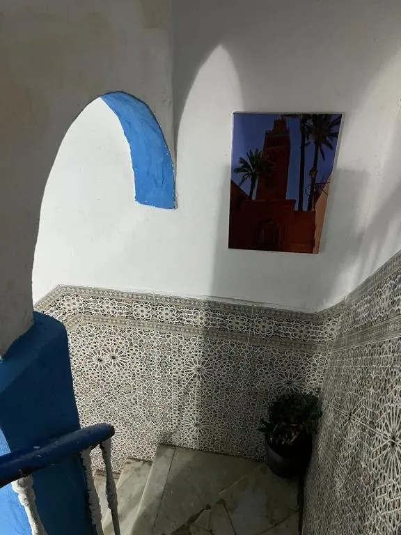 Stairway with art at Maison Bleu Hajja in Tangier