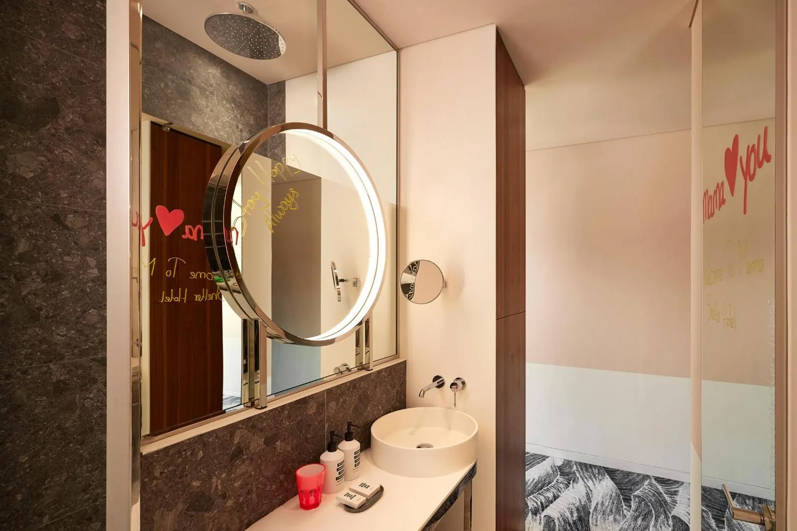 Bathroom at Mama Shelter Dubai with sink, mirror, and shower area