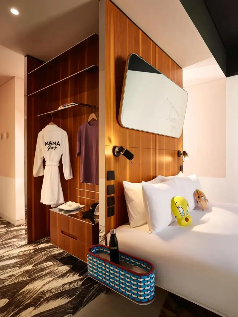 Closet and bed area in a Mama Shelter Dubai guest room with robes and luggage storage