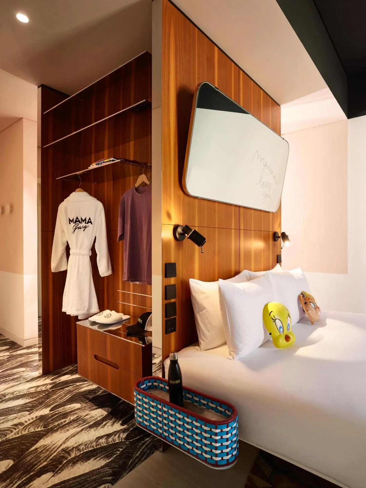 Closet and bed area in a Mama Shelter Dubai guest room with robes and luggage storage