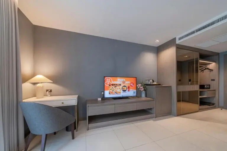 Guest room seating and TV area at Mandarin Eastville, Pattaya - SHA Extra Plus with modern furnishings and neutral tones.