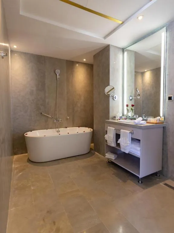 Stylish bathroom with bathtub at Mandarin Hotel & Spa Tanger