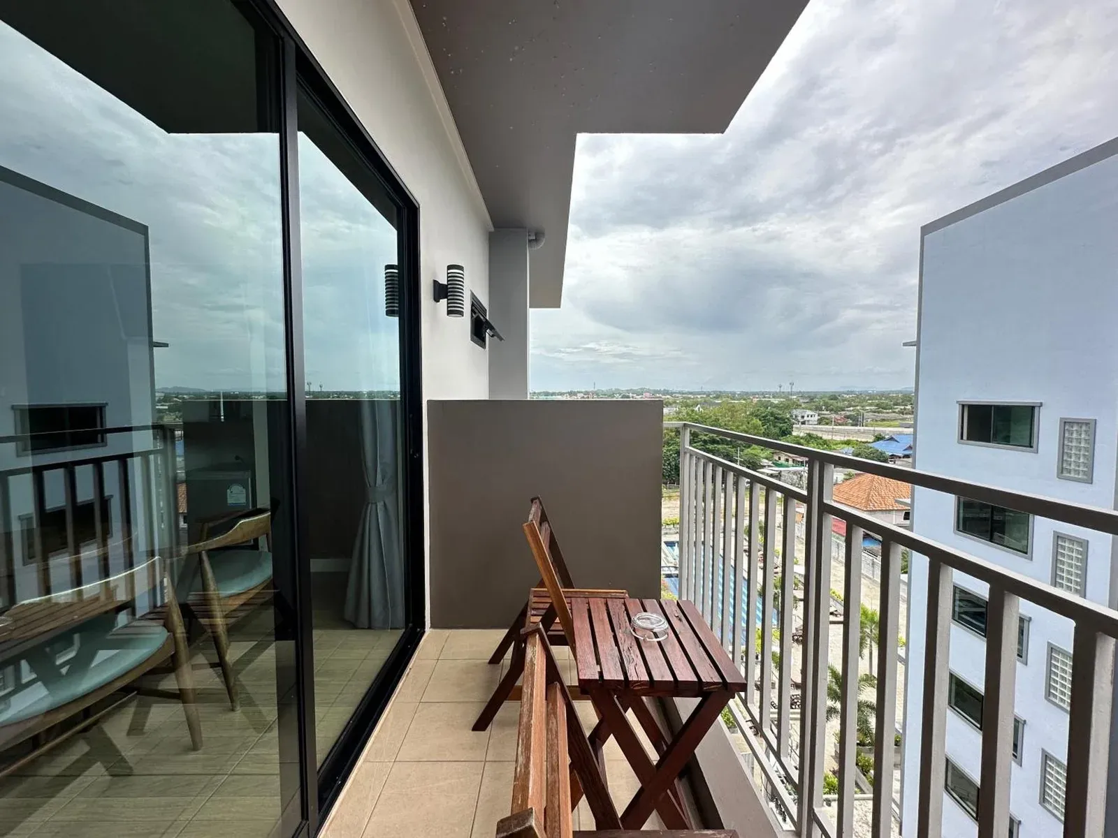 Balcony at Mangrove Prestige Hotel in Pattaya with seating and city view