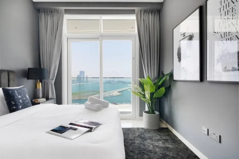 Cozy bedroom with waterfront views in Dubai hotel.