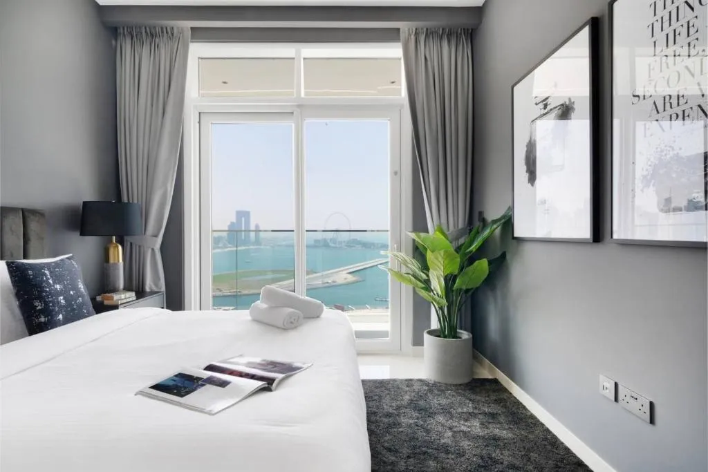 Cozy bedroom with waterfront views in Dubai hotel.