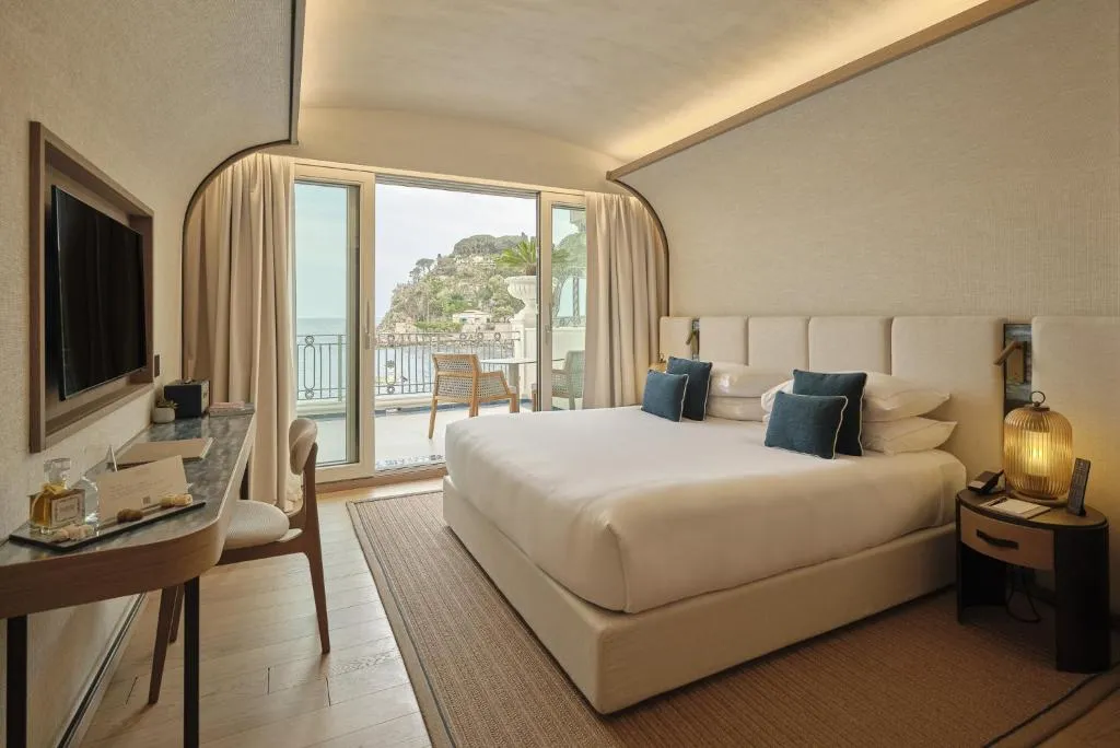 Luxurious bedroom in Mazzarò Sea Palace with balcony view