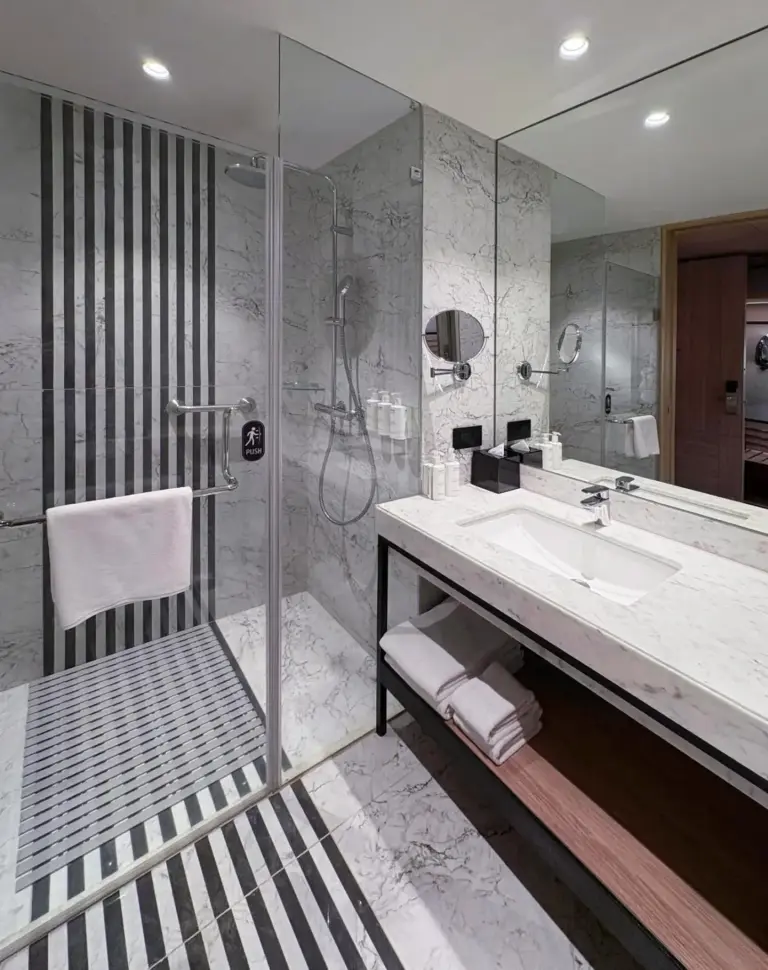 Modern bathroom at Mercure Kathmandu Sukedhara Heights with walk-in shower and marble finishes