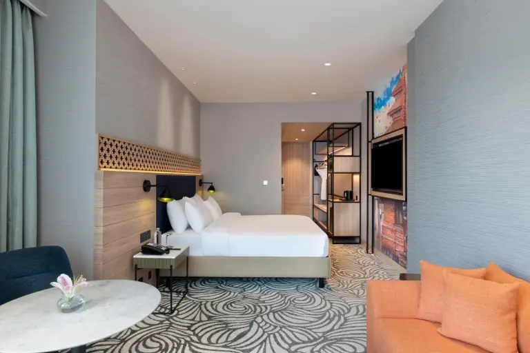 Guest room at Mercure Kathmandu Sukedhara Heights with king bed, work area, and modern artwork