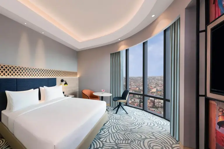 Panoramic guest room at Mercure Kathmandu Sukedhara Heights with curved windows and city views