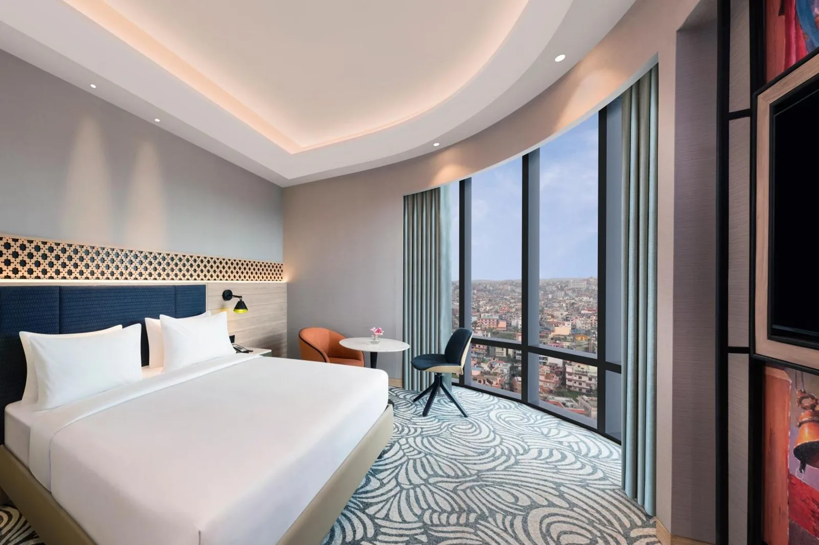 Panoramic guest room at Mercure Kathmandu Sukedhara Heights with curved windows and city views